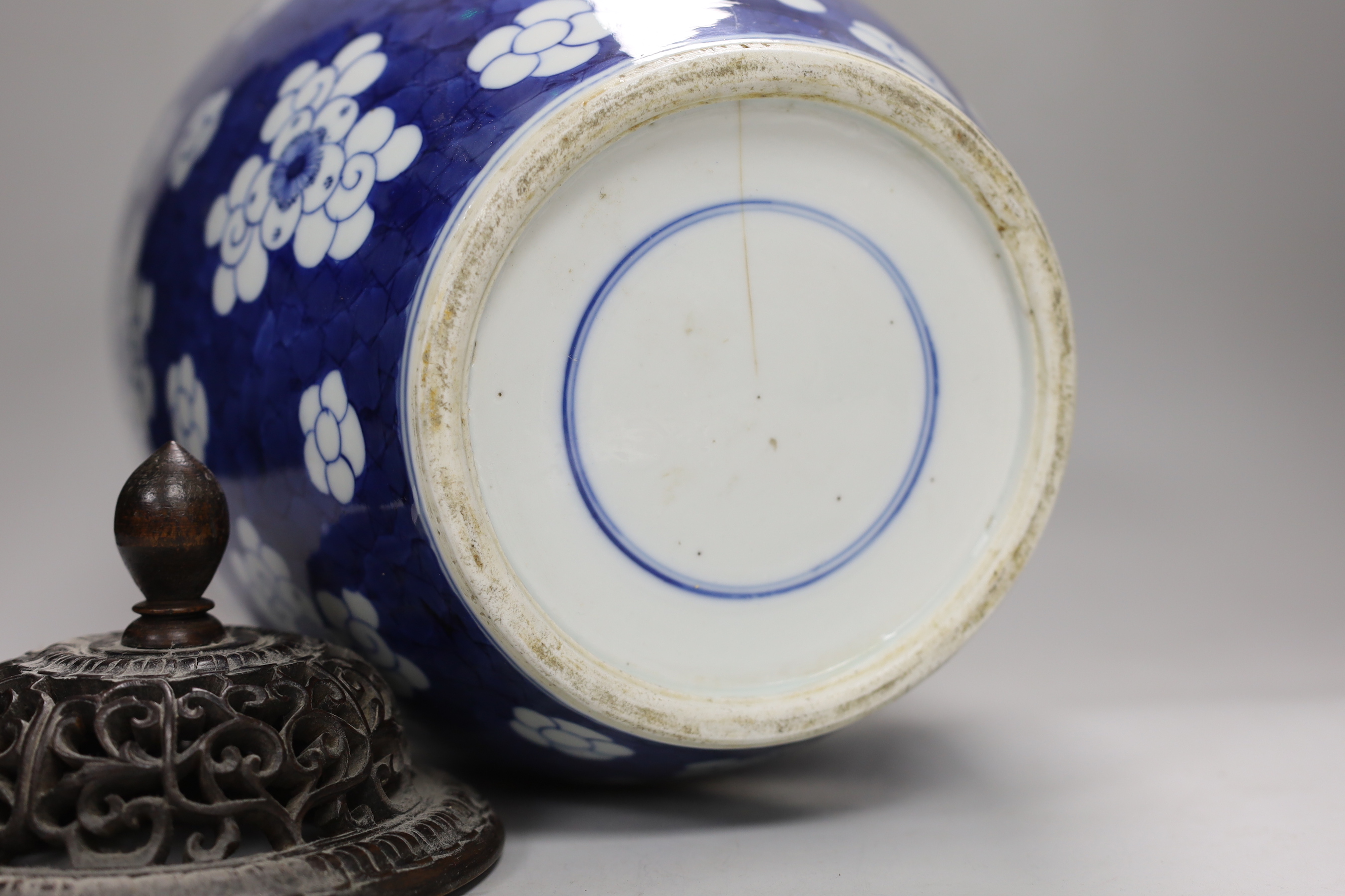 A large Chinese blue and white prunus pattern vase, with carved hardwood cover, 42cm (a.f.)